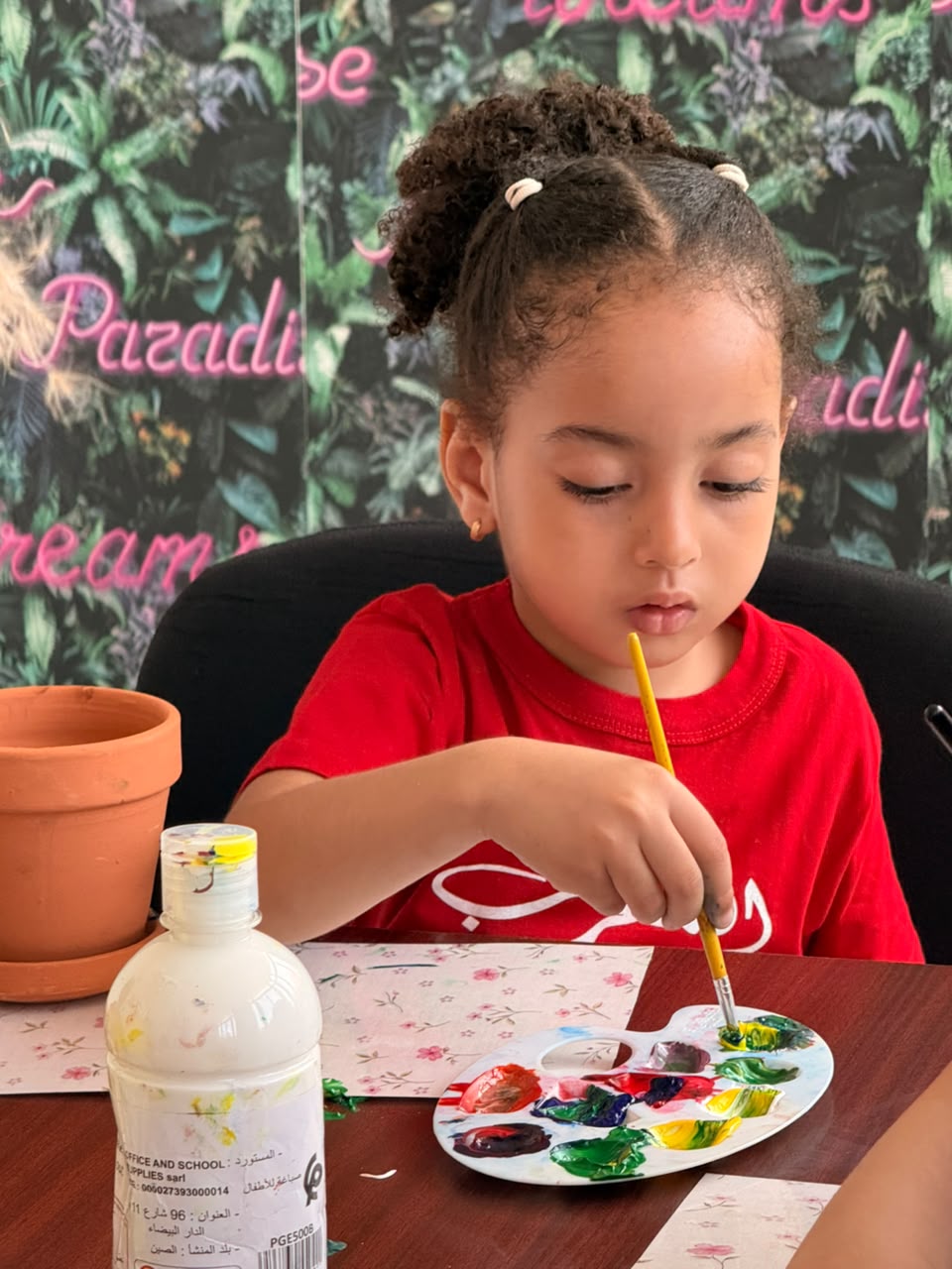 Jeune élève concentrée pendant un atelier de peinture